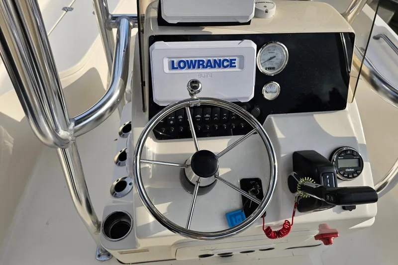 Slide: The Image of 2024 Bulls Bay 2200 boat console with steering wheel and navigation equipment. - 15