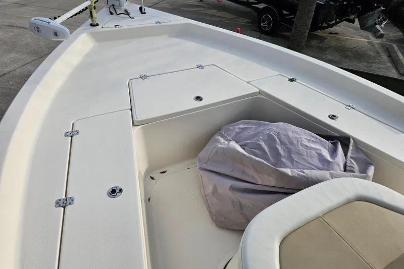 Slide: The Image of 2024 Bulls Bay 2200 boat deck with storage compartments and covered seating area. - 16