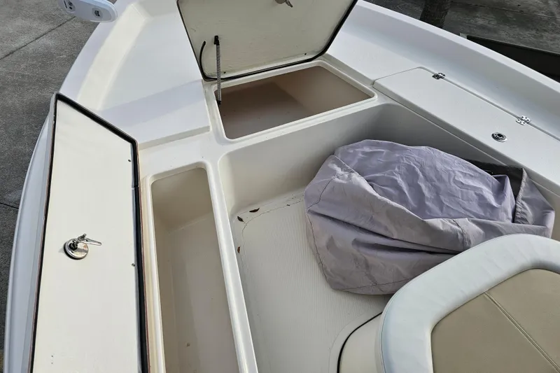 Slide: The Image of 2024 Bulls Bay 2200 boat interior storage compartments with cover and seating. - 18