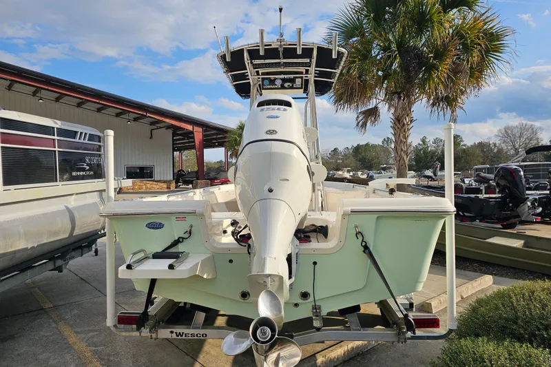 Slide: The Image of 2024 Bulls Bay 2200 boat on trailer, parked near palm tree and building. - 5