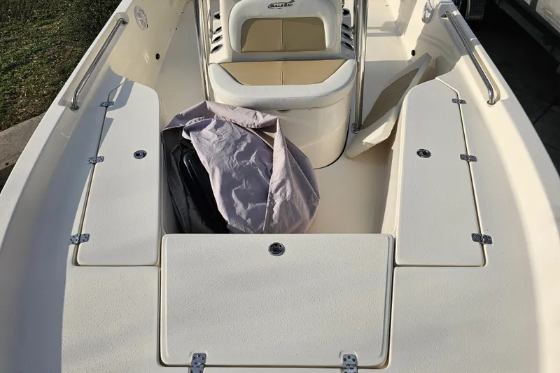 Slide: The Image of 2024 Bulls Bay 2200 boat interior with seating and storage compartments. - 8
