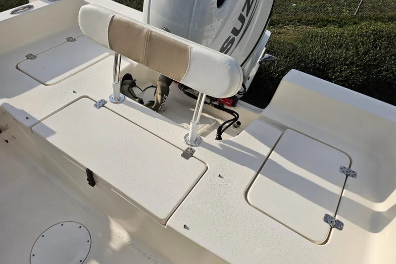 Slide: The Image of 2024 Bulls Bay 2200 boat deck with storage compartments and Suzuki engine. - 9