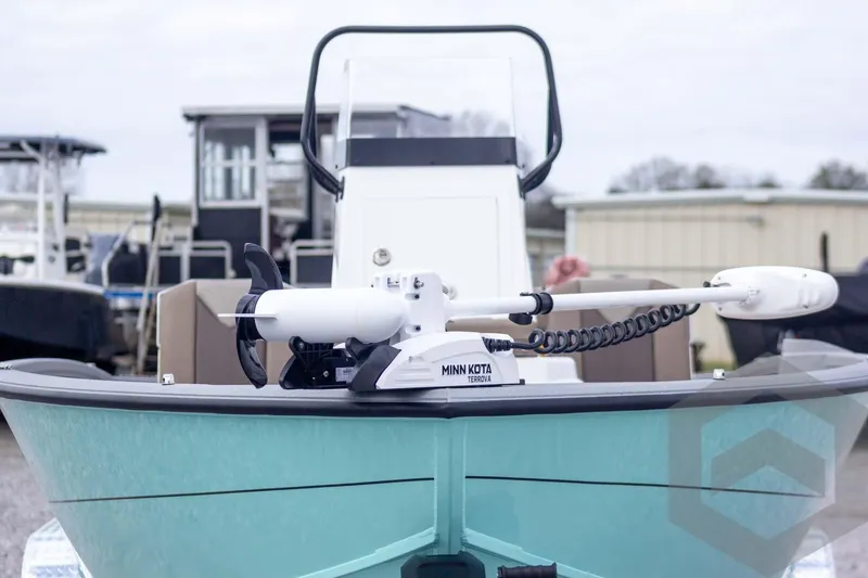 Slide: The Image of 2026 Vexus ACX 2150 boat with Minn Kota Terrova trolling motor, docked outdoors. - 2