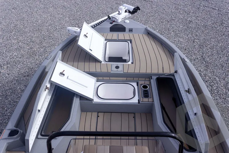 Slide: The Image of 2026 Vexus ACX 2150 boat interior with open storage compartments on a gravel surface. - 24