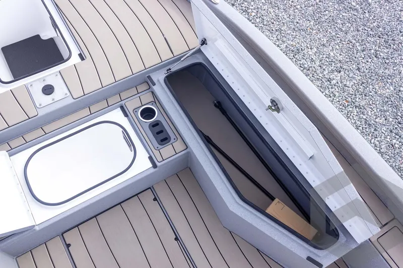 Slide: The Image of 2026 Vexus ACX 2150 boat interior with storage compartments and cup holder. - 26