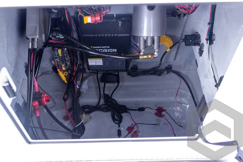Slide: The Image of Interior view of 2026 Vexus ACX 2150 boat's electrical compartment with Minn Kota charger. - 33