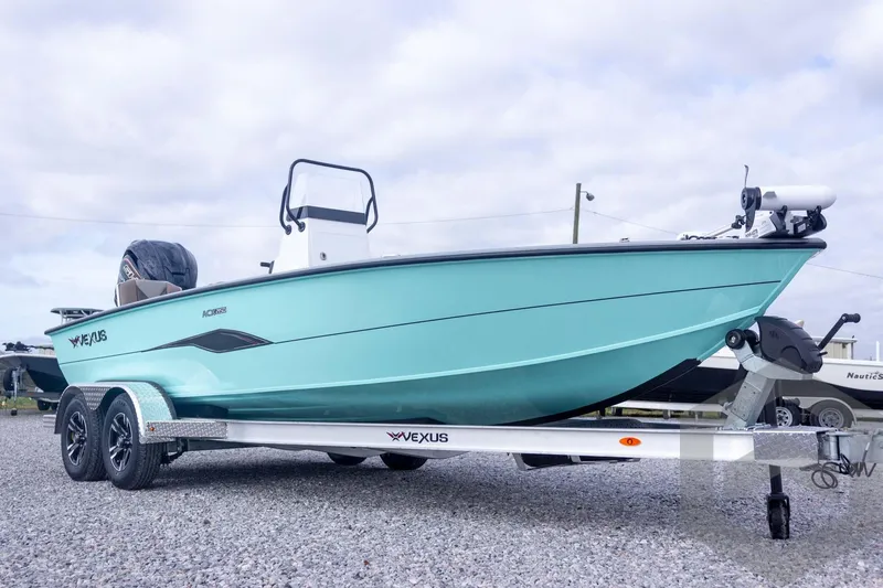 Slide: The Image of 2026 Vexus ACX 2150 boat on trailer, light blue hull, parked on gravel. - 8