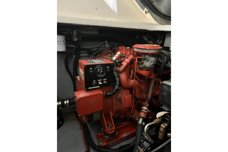 Slide: The Image of Engine compartment of a 1996 Sea Ray Sundancer 330 boat, featuring a red generator. - 4