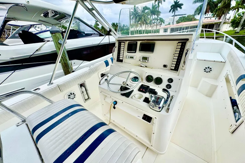 Slide: The Image of 1996 Marlin 35 CC Sportfish boat cockpit with steering wheel and control panel. - 13