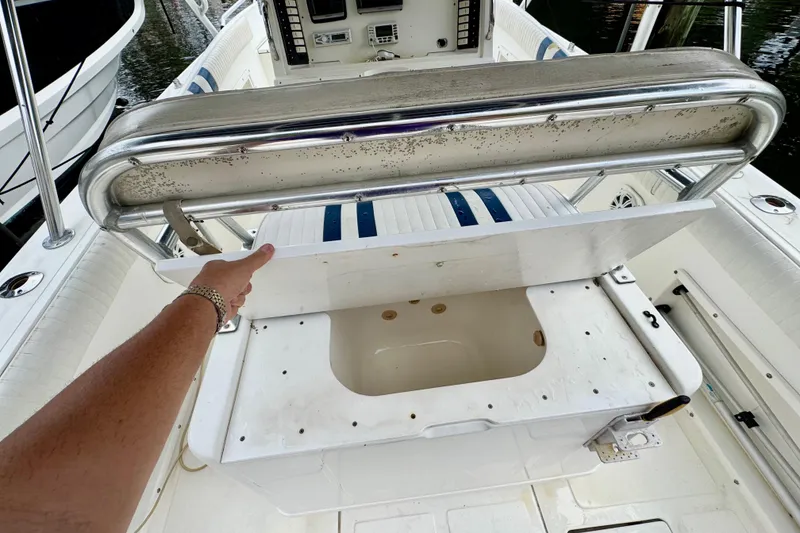 Slide: The Image of 1996 Marlin 35 CC Sportfish boat interior with cuddy cabin, docked near palm trees. - 23