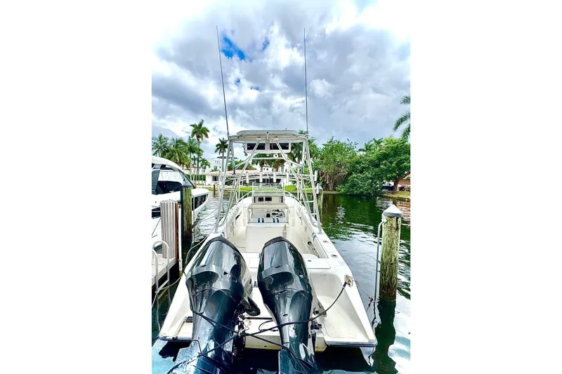 Slide: The Image of 1996 Marlin 35 CC Sportfish boat with cuddy, featuring dual outboard motors and white seating. - 4