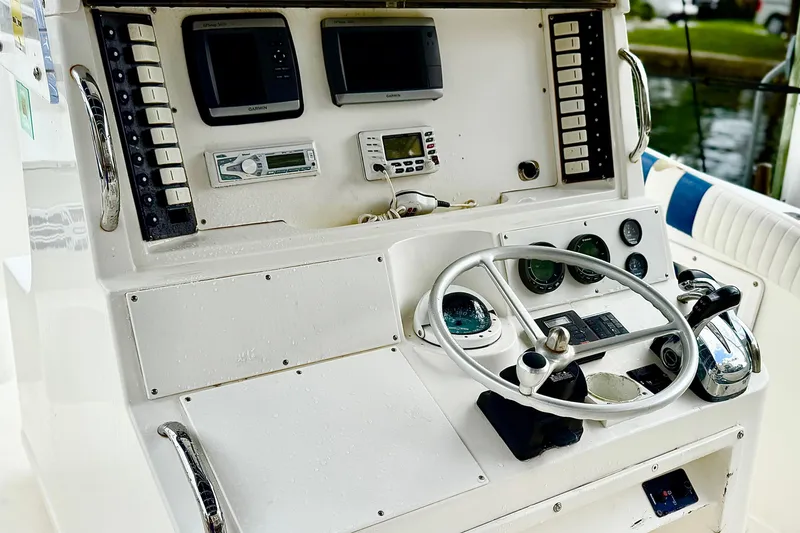 Slide: The Image of 1996 Marlin 35 CC Sportfish boat interior with storage compartment and metal railing. - 9