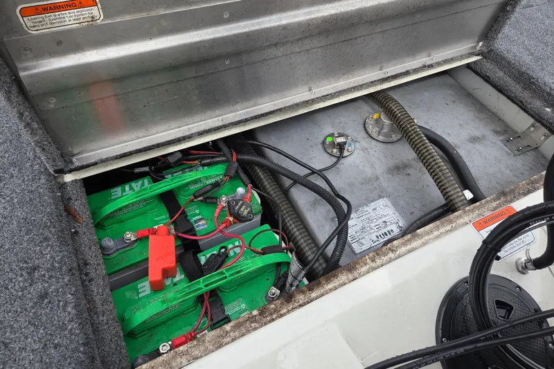 Slide: The Image of 2021 Tracker Pro Team 190 TX boat battery compartment with wiring and components. - 13