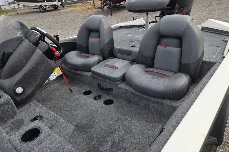 Slide: The Image of 2021 Tracker Pro Team 190 TX boat interior with gray seating and steering console. - 15