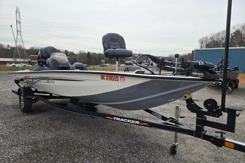 Slide: The Image of 2021 Tracker Pro Team 190 TX boat on trailer, parked outdoors. - 2