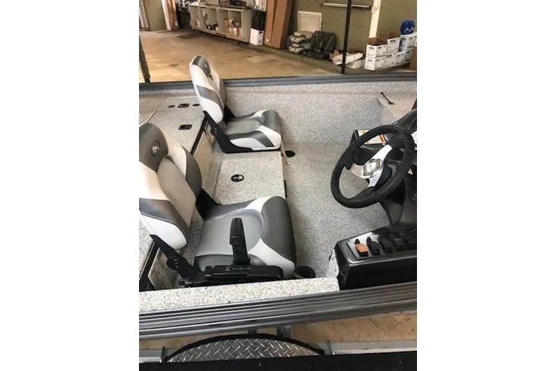 Slide: The Image of 2022 POLARKRAFT Bass Tx 165 boat interior with seats and steering wheel. - 4