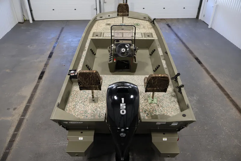 Slide: The Image of 2022 Tracker Grizzly 2072 MVX CC boat with Mercury 150 engine in a garage. - 10