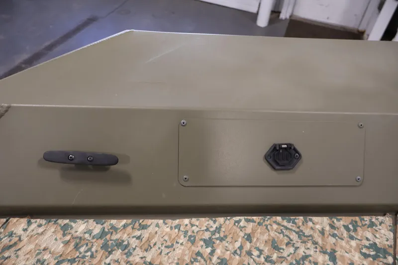 Slide: The Image of 2022 Tracker Grizzly 2072 MVX CC boat detail with cleat and hatch, indoors. - 11