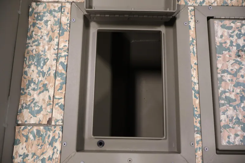 Slide: The Image of Storage compartment in 2022 Tracker Grizzly 2072 MVX CC boat with camo pattern. - 15