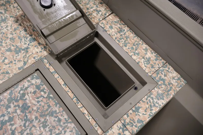 Slide: The Image of 2022 Tracker Grizzly 2072 MVX CC boat storage compartment with camouflage pattern. - 17