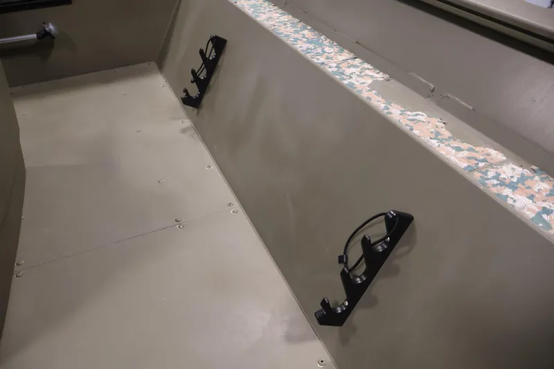 Slide: The Image of 2022 Tracker Grizzly 2072 MVX CC interior with rod holders and camo accents. - 19