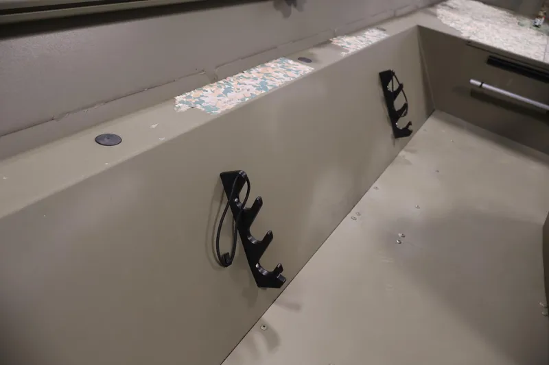 Slide: The Image of 2022 Tracker Grizzly 2072 MVX CC interior with rod holders and camouflage accents. - 20