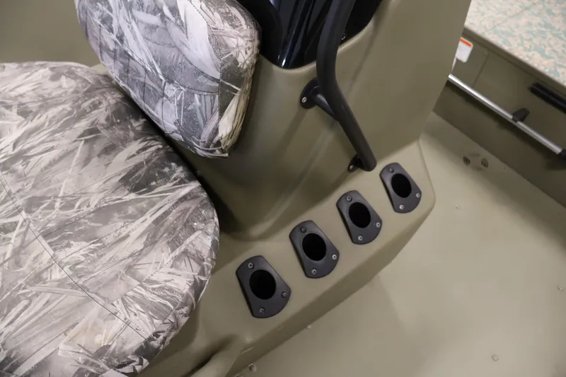Slide: The Image of 2022 Tracker Grizzly 2072 MVX CC boat interior with camo seat and rod holders. - 22