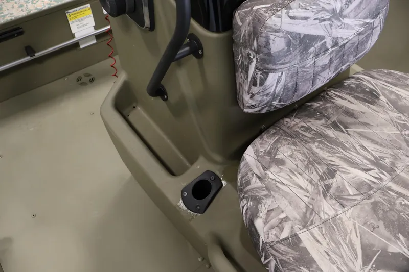 Slide: The Image of 2022 Tracker Grizzly 2072 MVX CC boat interior with camo seats and console. - 23