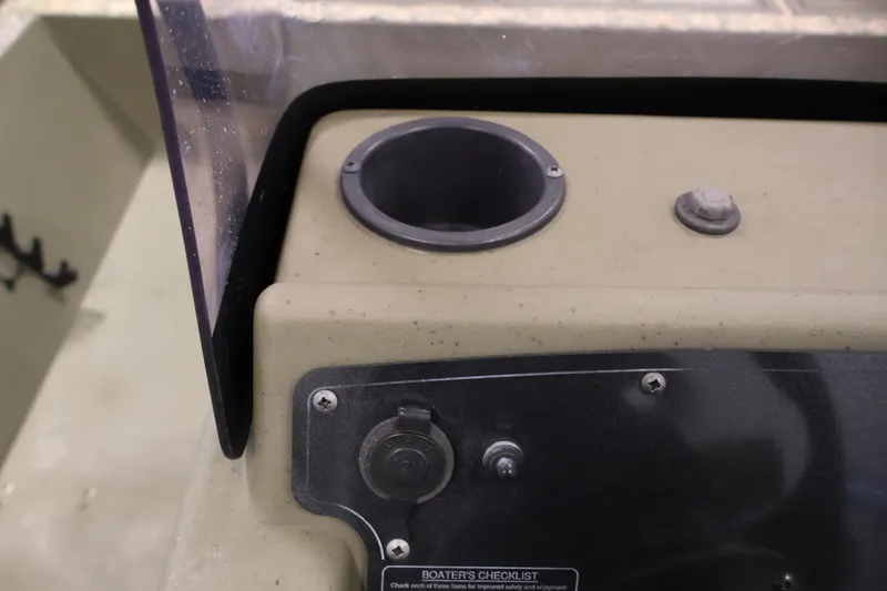 Slide: The Image of 2022 Tracker Grizzly 2072 MVX CC dashboard with cup holder and control panel. - 26