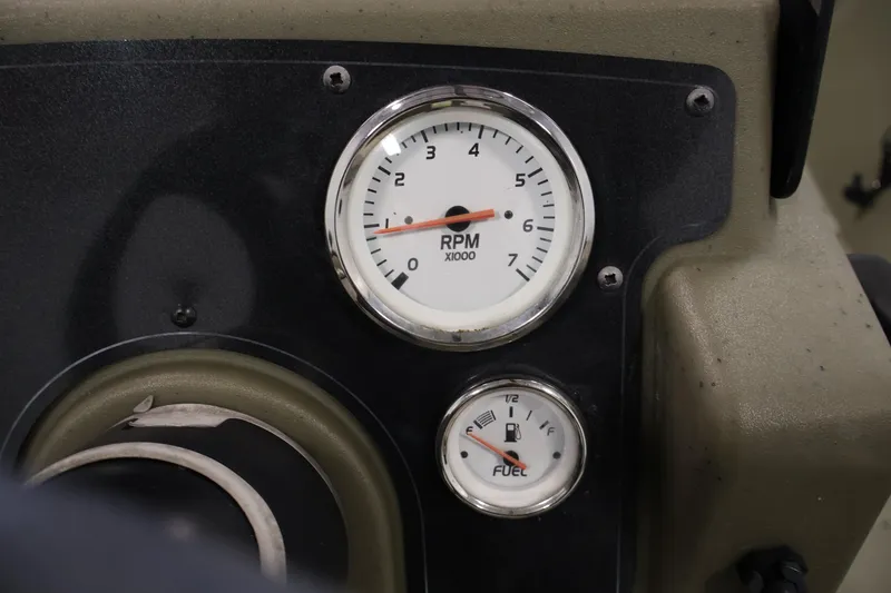Slide: The Image of Dashboard of 2022 Tracker Grizzly 2072 MVX CC with RPM and fuel gauges. - 27