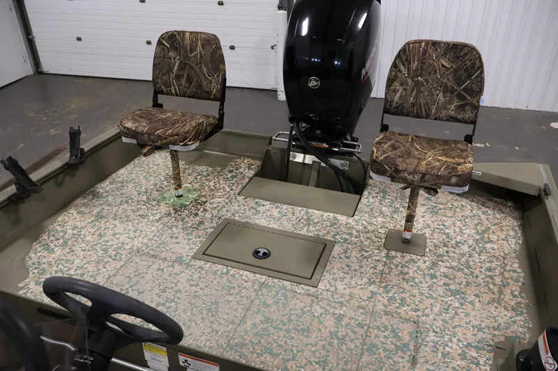 Slide: The Image of 2022 Tracker Grizzly 2072 MVX CC boat interior with camo seats and motor. - 29
