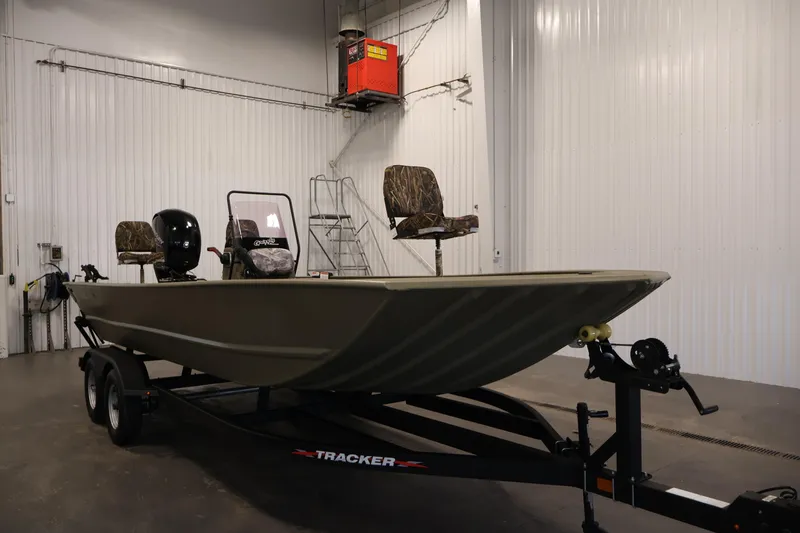 Slide: The Image of 2022 Tracker Grizzly 2072 MVX CC boat on trailer in indoor storage. - 3