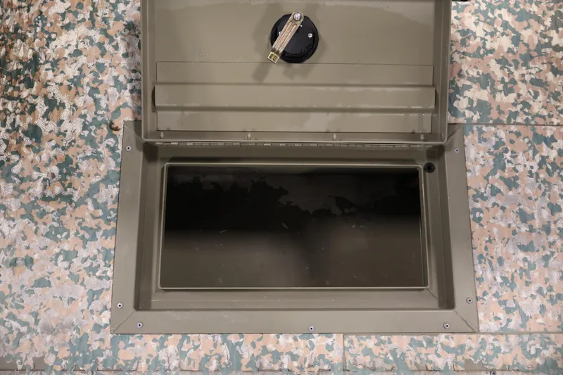 Slide: The Image of Open storage compartment on 2022 Tracker Grizzly 2072 MVX CC boat with camouflage pattern. - 30