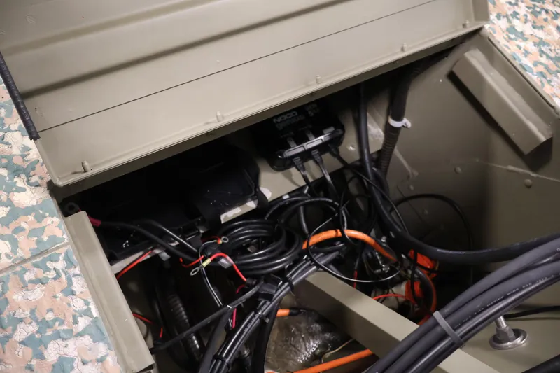 Slide: The Image of 2022 Tracker Grizzly 2072 MVX CC boat wiring compartment with cables and connectors. - 32