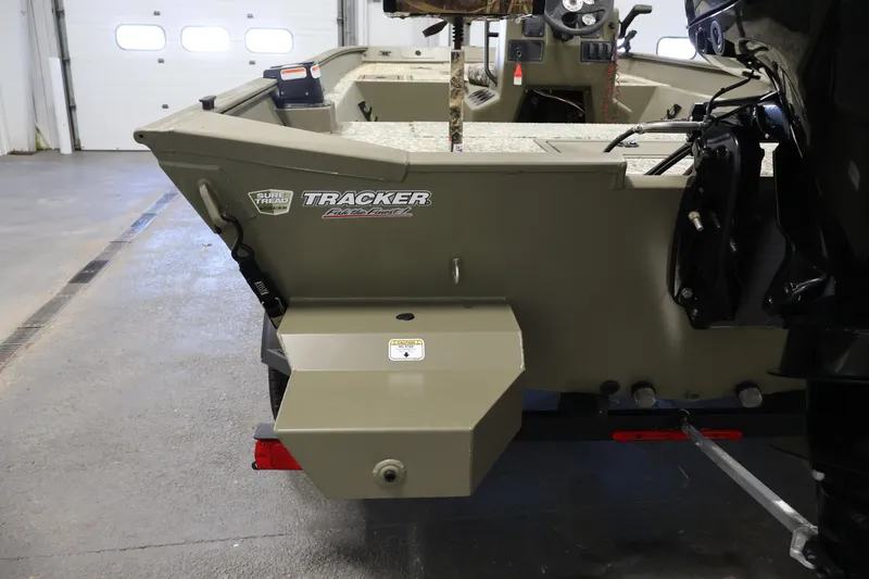 Slide: The Image of 2022 Tracker Grizzly 2072 MVX CC boat interior in a garage setting. - 35