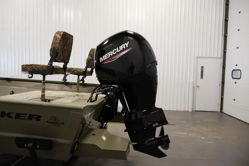 Slide: The Image of 2022 Tracker Grizzly 2072 MVX CC boat with Mercury outboard motor in a garage. - 36