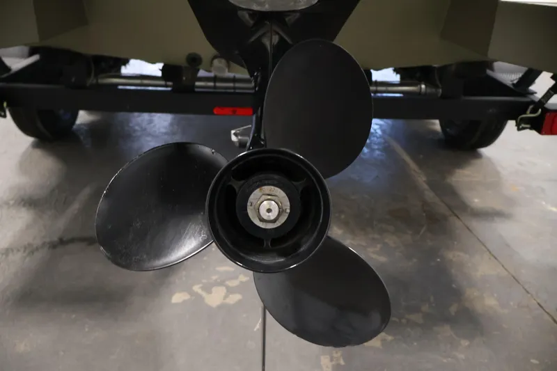 Slide: The Image of 2022 Tracker Grizzly 2072 MVX CC boat propeller close-up in garage setting. - 39