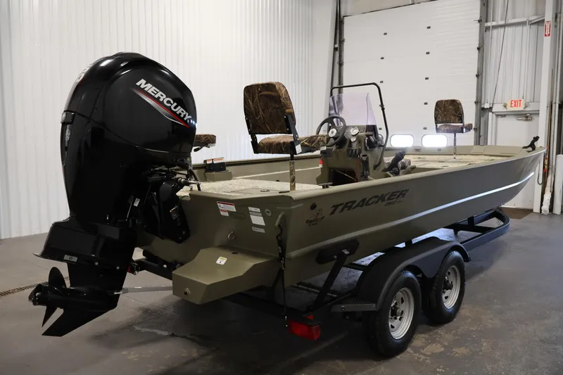 Slide: The Image of 2022 Tracker Grizzly 2072 MVX CC boat with Mercury engine in a garage. - 5