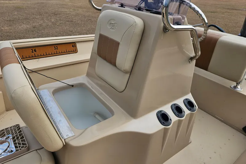 Slide: The Image of G3 Bay 17 boat interior, featuring a beige console with rod holders and cushioned seating, 2022 model. - 16