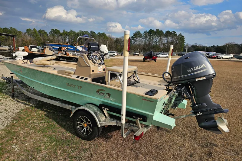 Slide: The Image of 2022 G3 Bay 17 boat with Yamaha motor on trailer, parked outdoors. - 3
