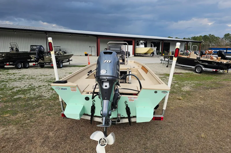 Slide: The Image of 2022 G3 Bay 17 boat with 70 HP motor, parked outdoors near storage facility. - 8