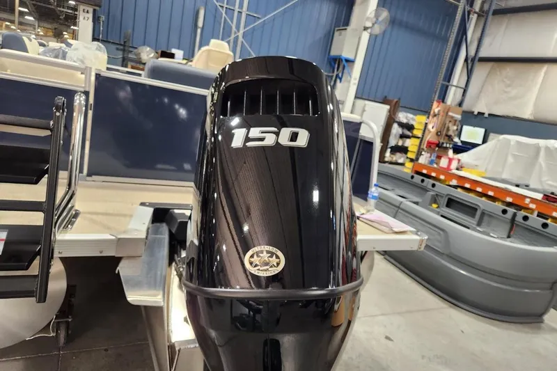 Slide: The Image of Outboard motor on 2026 Avalon LSZ Elite 21' boat in a workshop setting. - 4