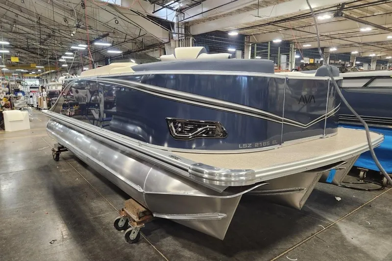 Slide: The Image of 2026 Avalon LSZ Elite 21' pontoon boat in a factory setting. - 7