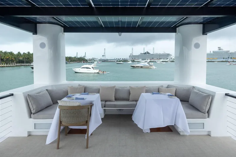 Slide: The Image of Luxurious ARKHAUS Villa 50 yacht deck with elegant seating, ocean view, and dining setup, 2025 model. - 13