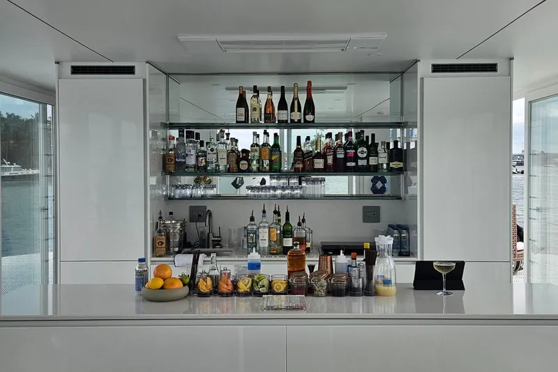Slide: The Image of Luxurious ARKHAUS Villa 50 bar interior with assorted spirits and fruit garnishes, 2025 model. - 14
