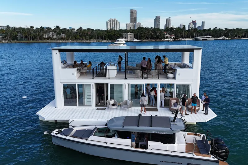 Slide: The Image of Floating ARKHAUS Villa 50, 2025 model, with people enjoying rooftop and deck, city skyline backdrop. - 2