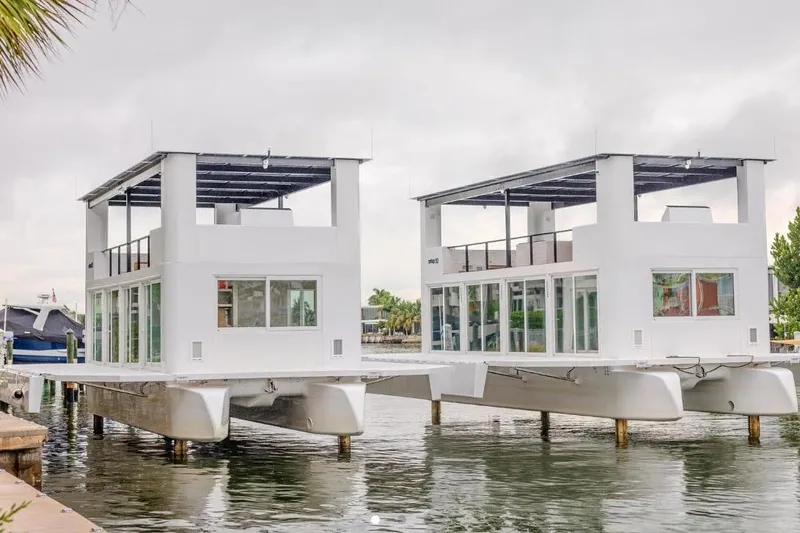 Slide: The Image of Floating ARKHAUS Villa 50, 2025 model, on water with modern design and large windows. - 4