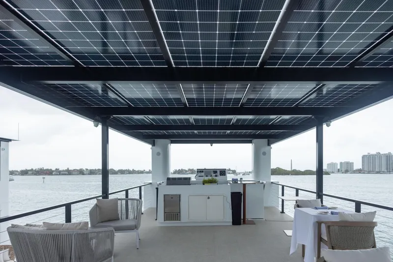 Slide: The Image of Modern ARKHAUS Villa 50 houseboat with solar panels, elegant seating, and waterfront view, 2025 model. - 5