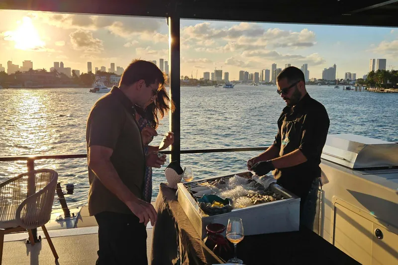 Slide: The Image of Sunset gathering on ARKHAUS Villa 50, 2025, with city skyline and waterfront views. - 9