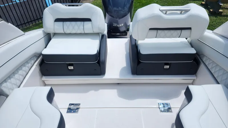 Slide: The Image of 2026 Regal LX4 boat interior with white cushioned seating and a 250 horsepower engine. - 12